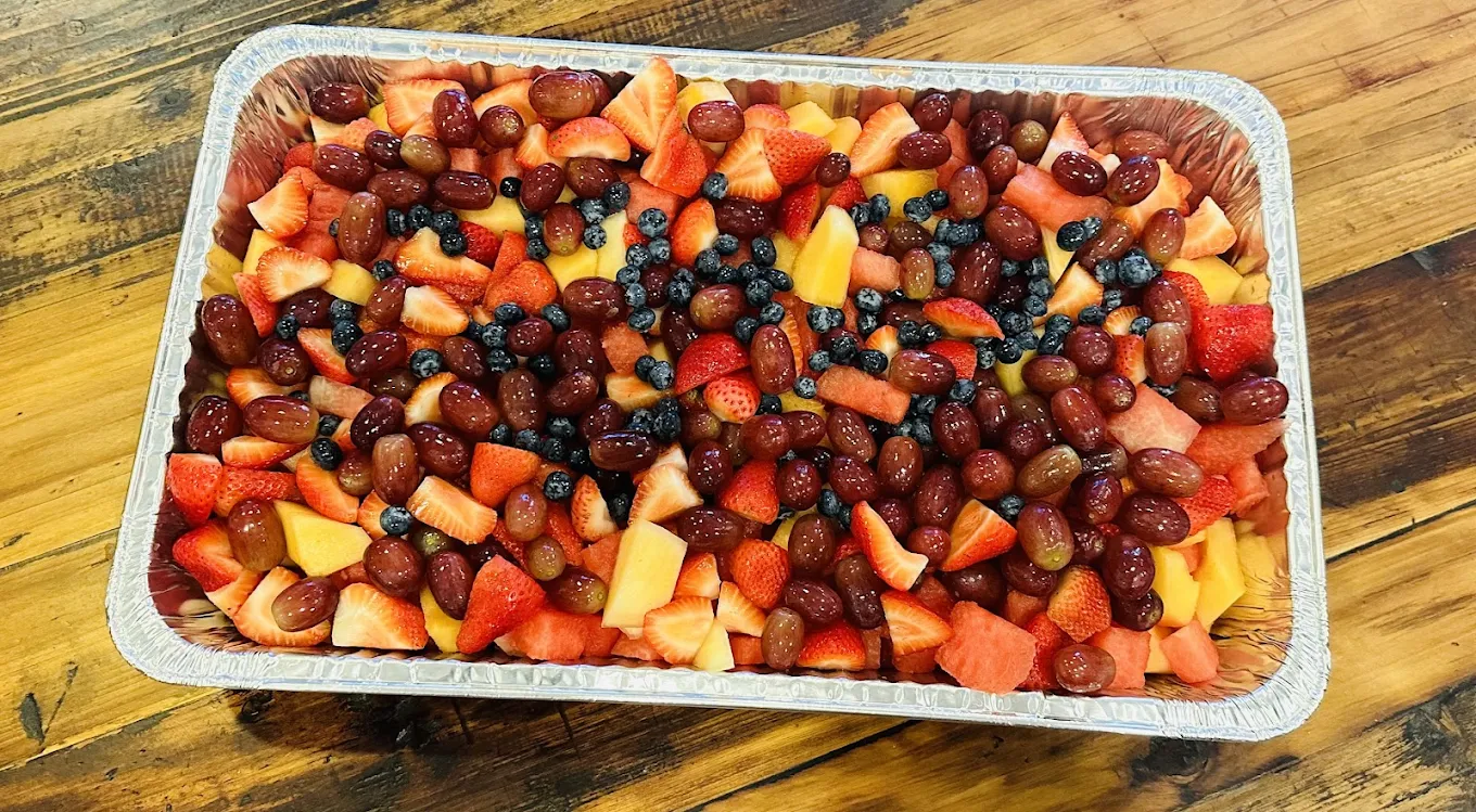 Fresh fruit platter with strawberries, blueberries, pineapple and grapes